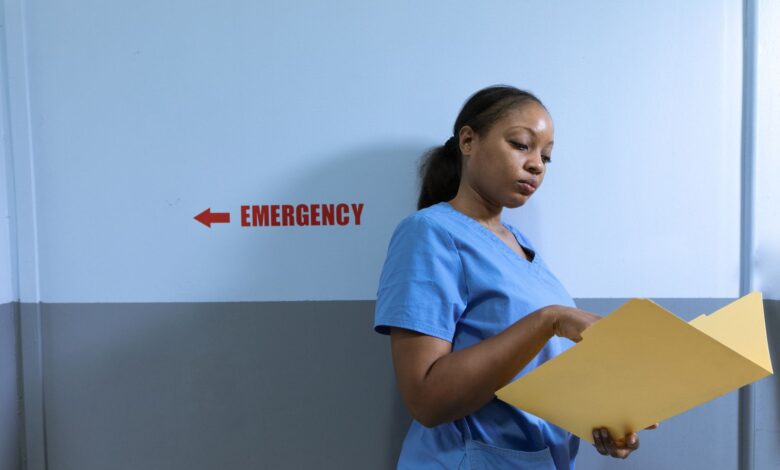 A nurse walking through a hospital hallway in scrubs, representing healthcare staffing