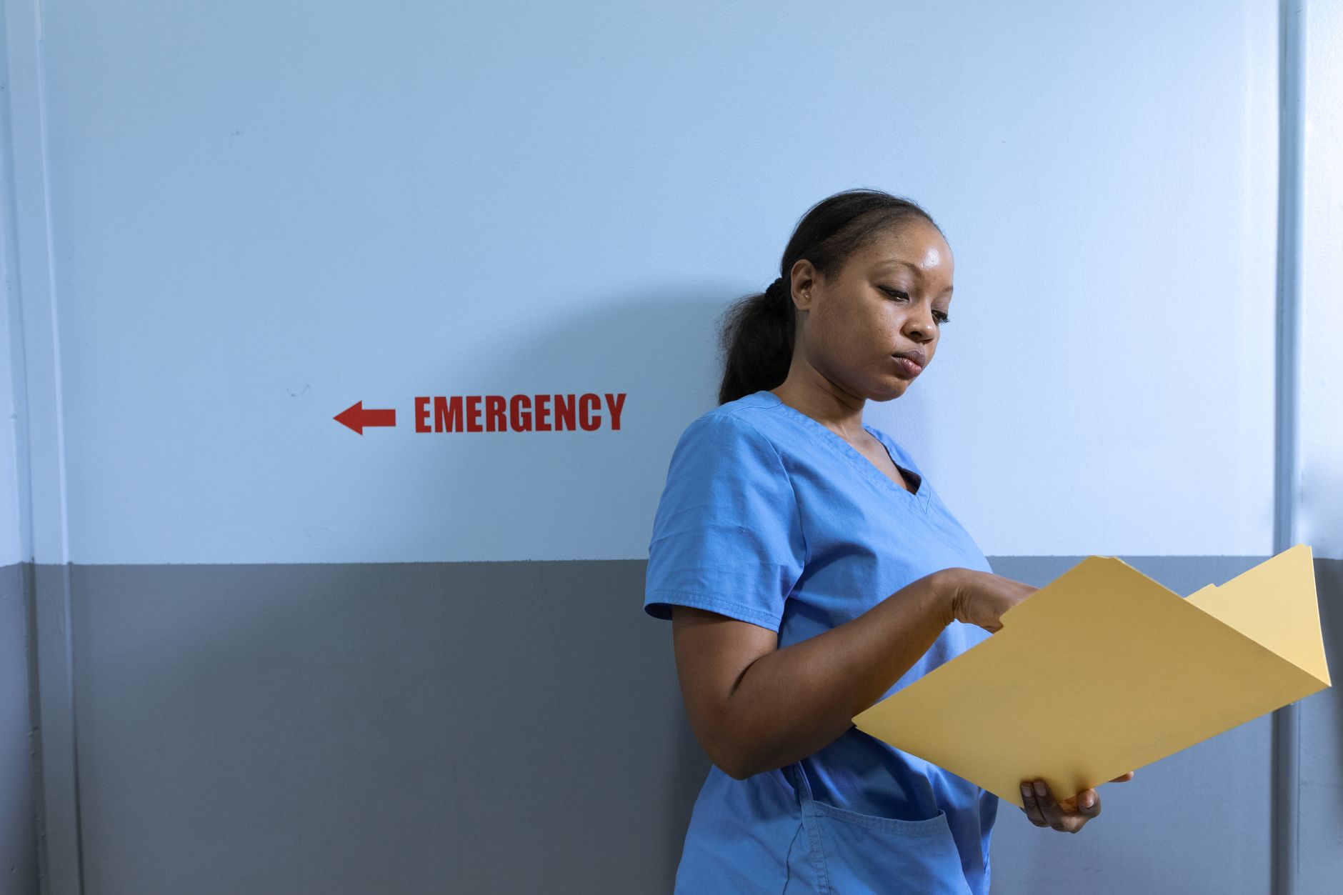 A nurse walking through a hospital hallway in scrubs, representing healthcare staffing