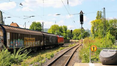 A long freight train carrying intermodal containers across open countryside