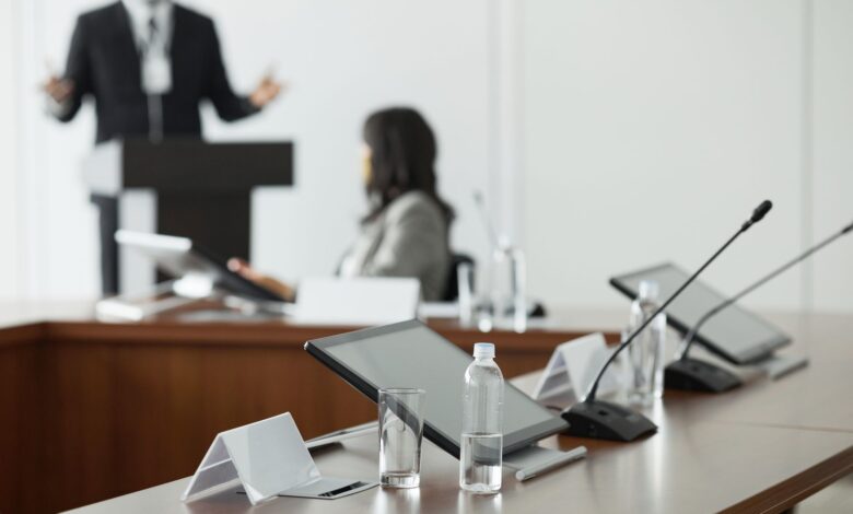 Empty corporate boardroom with long conference table and office chairs