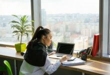 Professional working at a financial office desk reviewing investment data