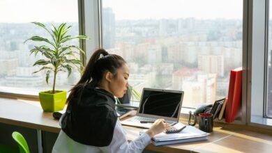 Professional working at a financial office desk reviewing investment data