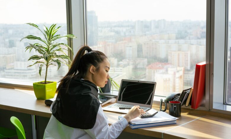 Professional working at a financial office desk reviewing investment data