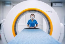 Radiologist reviewing medical scans on a digital workstation in a clinical setting