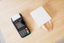A retail payment terminal sitting on a store counter representing merchant payment processing