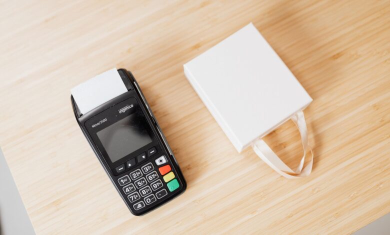 A retail payment terminal sitting on a store counter representing merchant payment processing