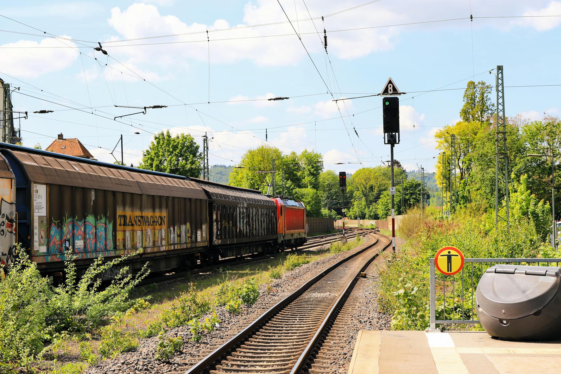 A long freight train carrying intermodal containers across open countryside