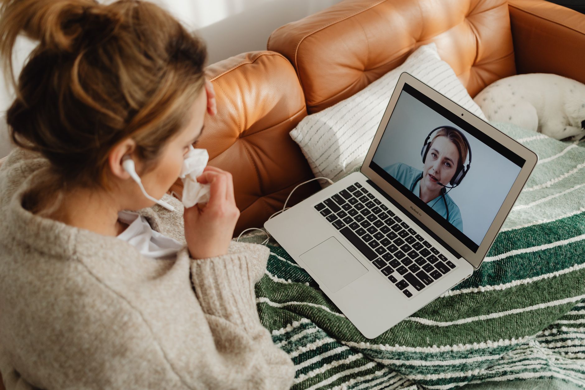 Patient on a video call with a healthcare provider using a tablet for remote medical consultation