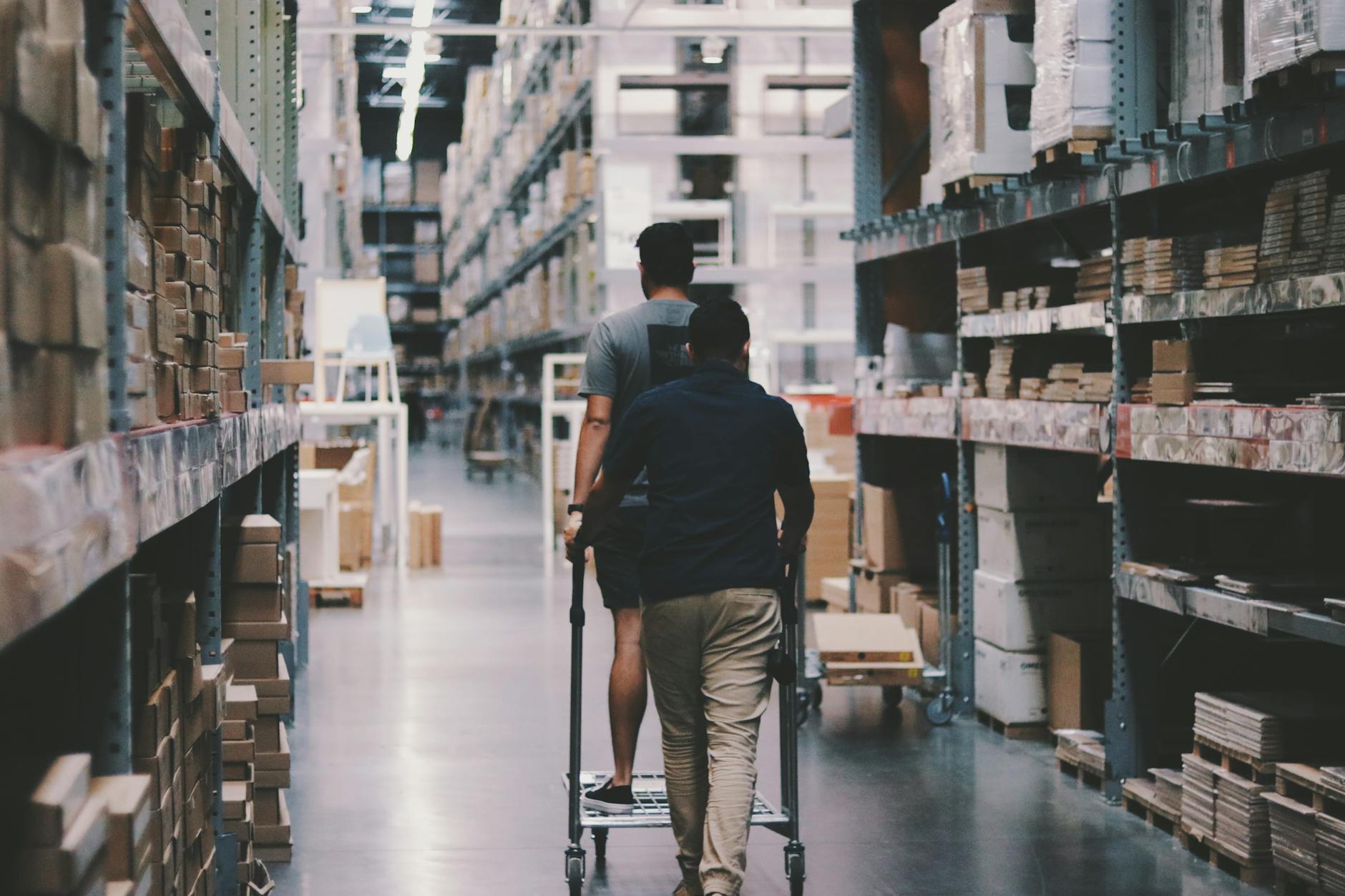 Workers inside a large warehouse managing freight and shipping operations