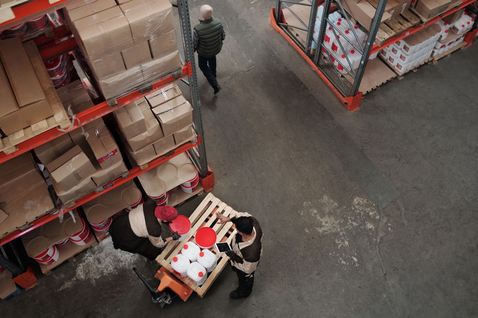 Workers in a warehouse facility handling logistics and inventory tasks