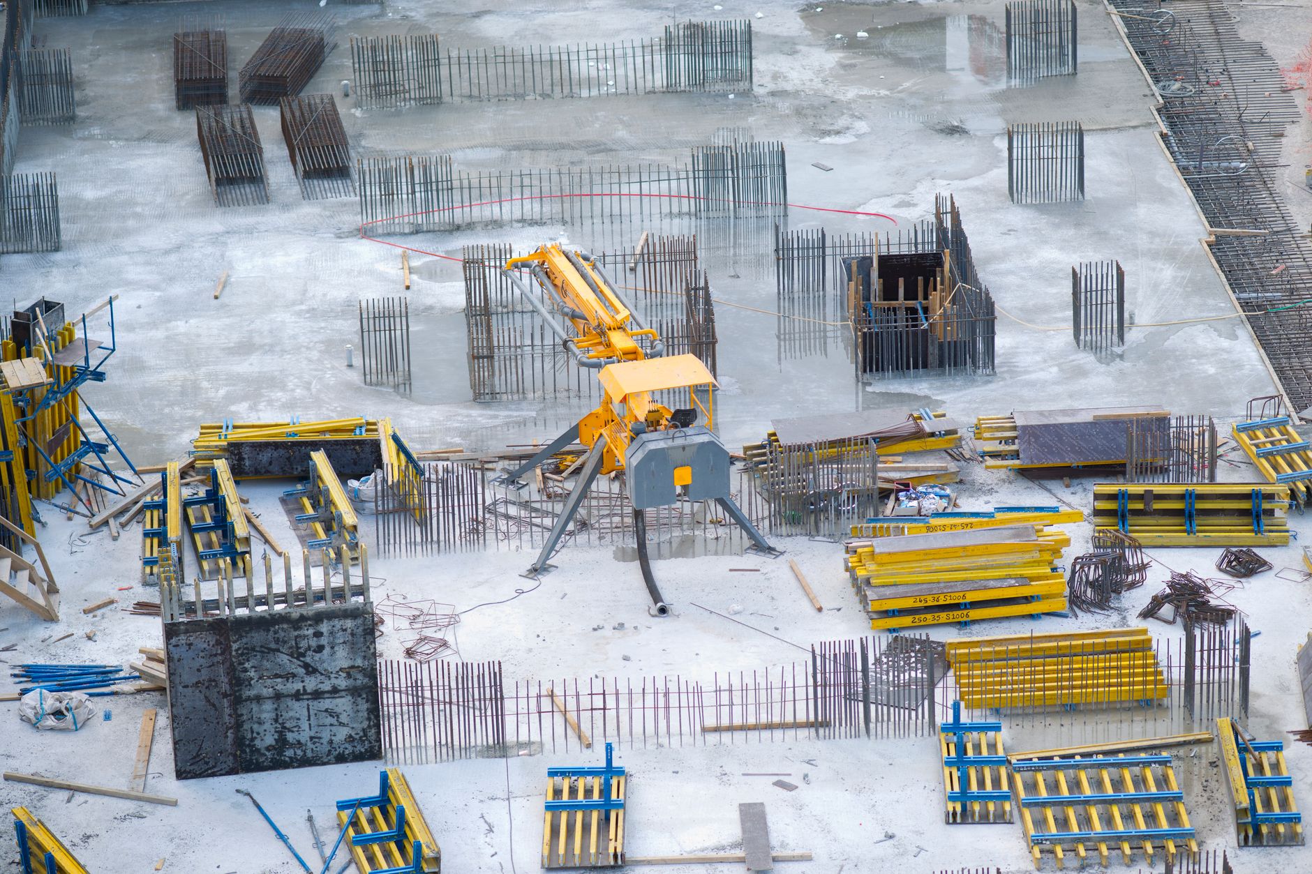 Aerial view of a large construction site with cranes and structural framework