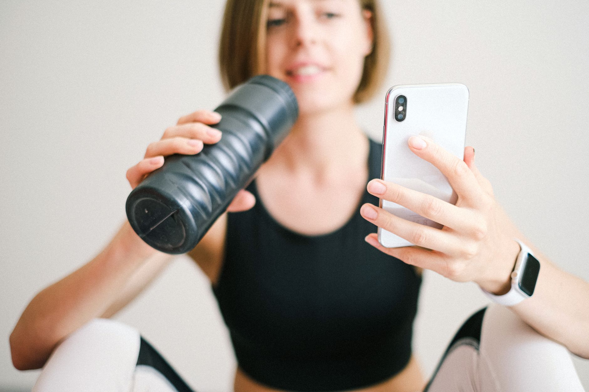 Person scrolling through a fitness booking app on a smartphone
