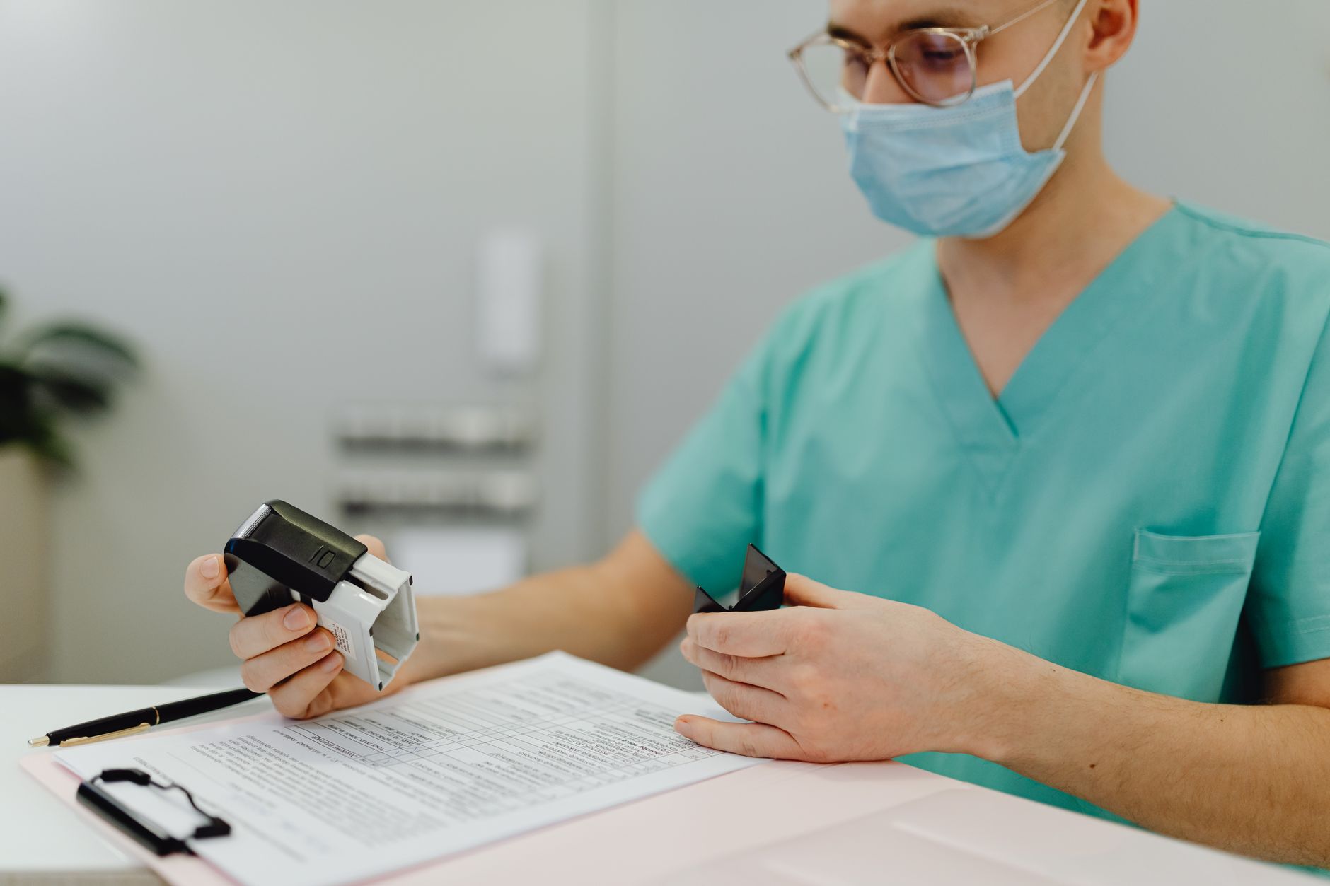 Healthcare billing documents spread across a desk with a calculator