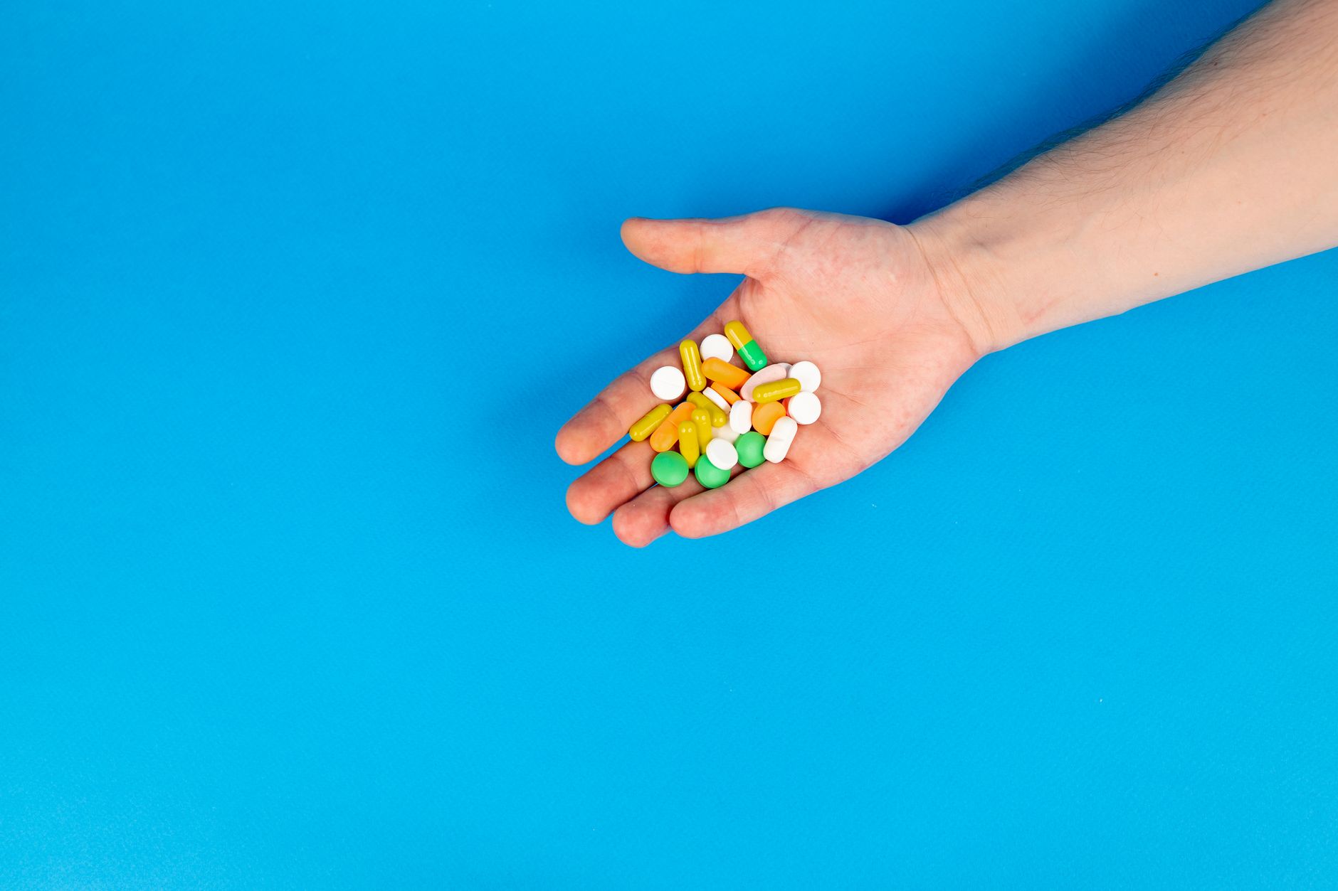 Bottles of prescription medication lined up on a pharmacy shelf