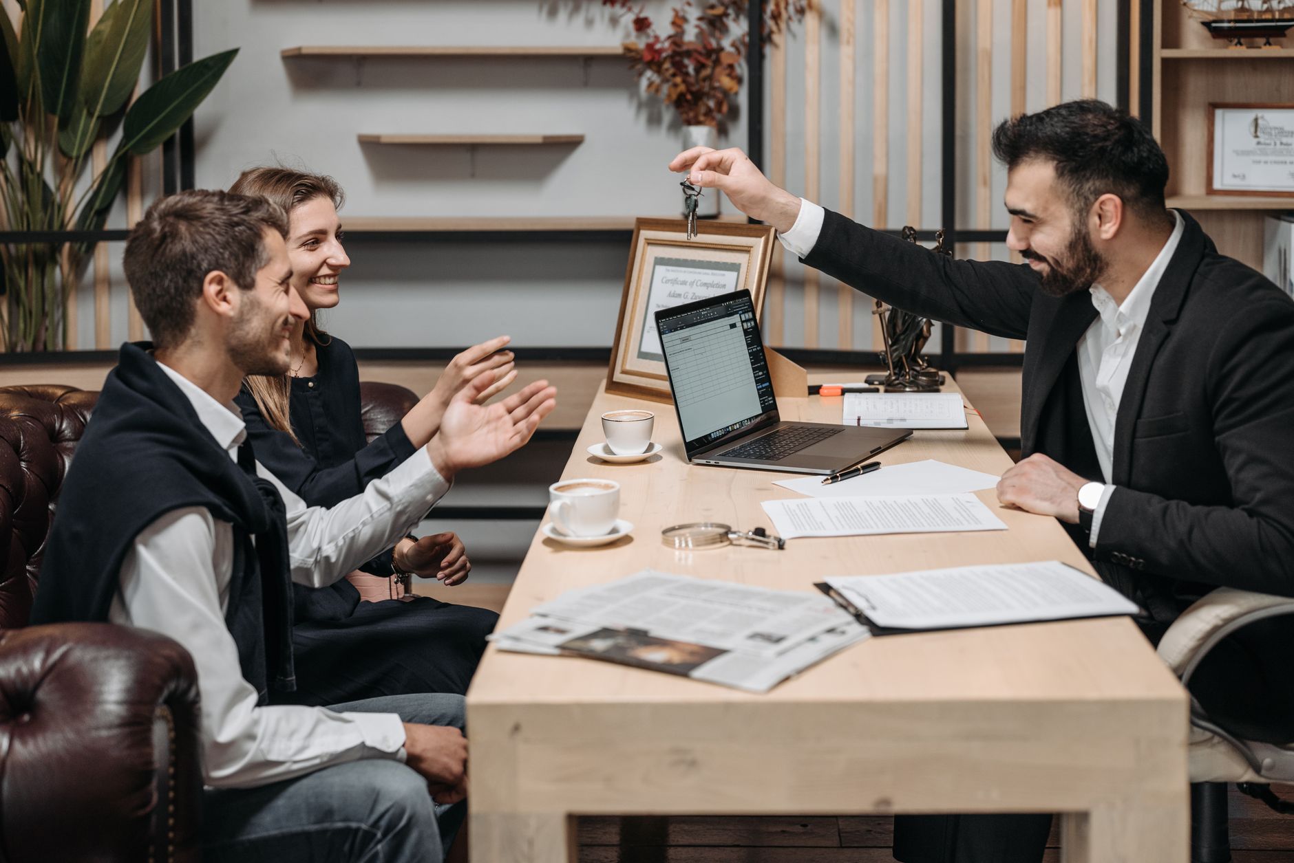 Business professionals reviewing real estate investment documents at a conference table