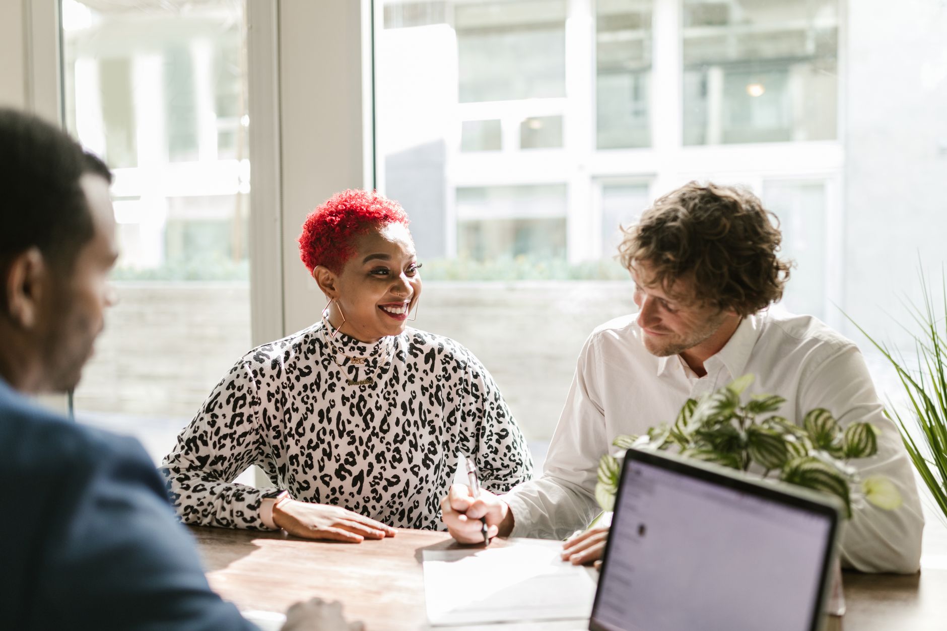 Loan officer meeting with a client at a community bank desk
