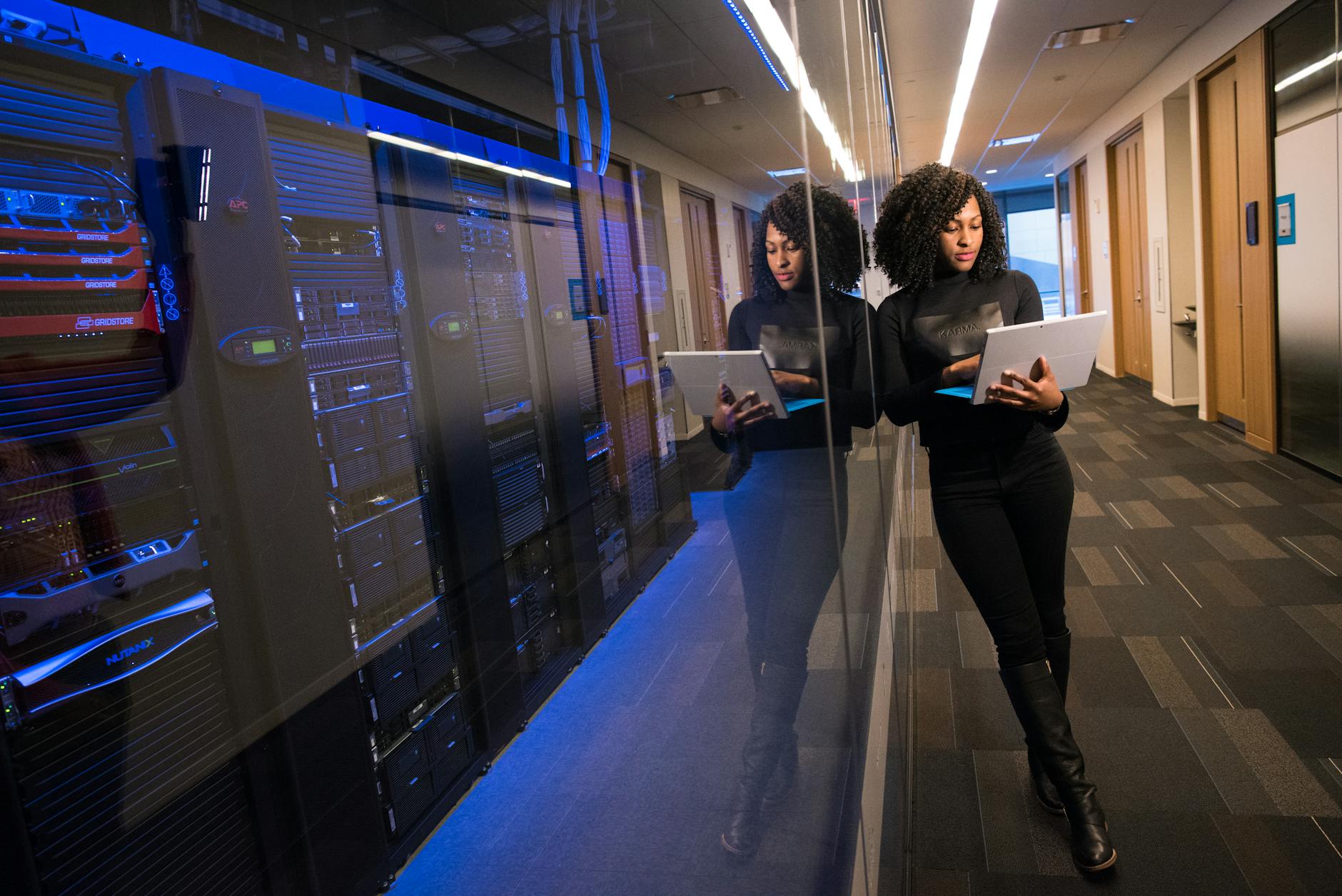 Rows of illuminated server racks inside a large data center facility