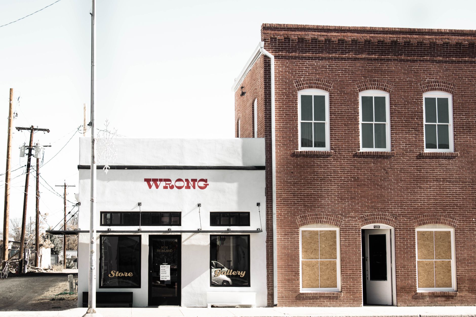Vacant commercial storefront with empty windows in a suburban strip mall