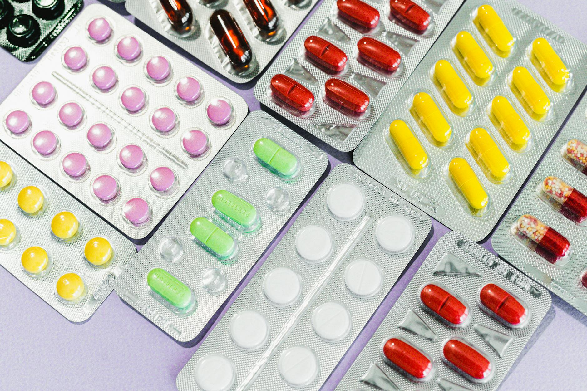 Close-up of prescription medication bottles arranged on a pharmacy shelf