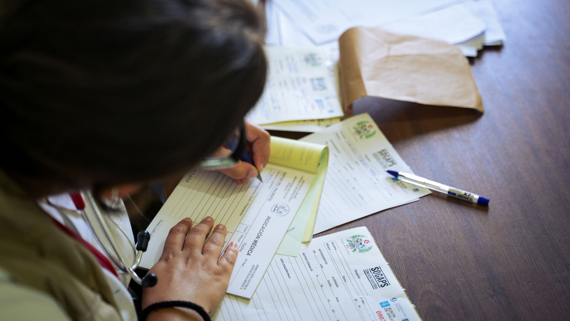 Healthcare administrator reviewing medical ownership and compliance paperwork