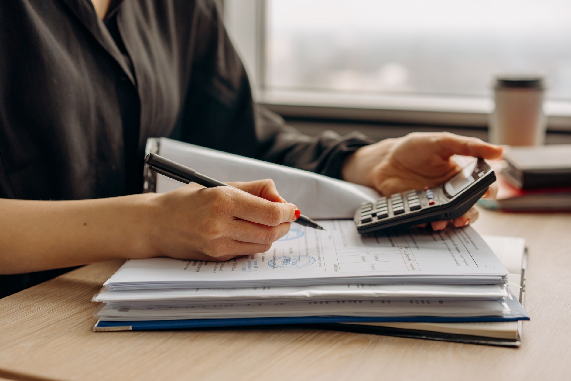 Financial documents and charts spread across a desk during a business review