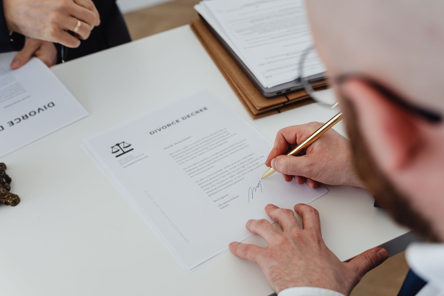 Stack of legal documents and a pen on a wooden office desk