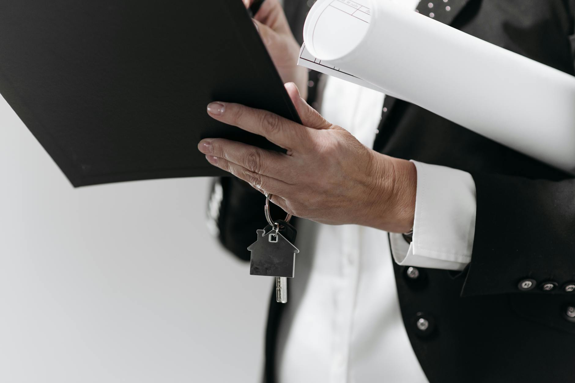 Real estate agent and client reviewing and signing property documents at a table