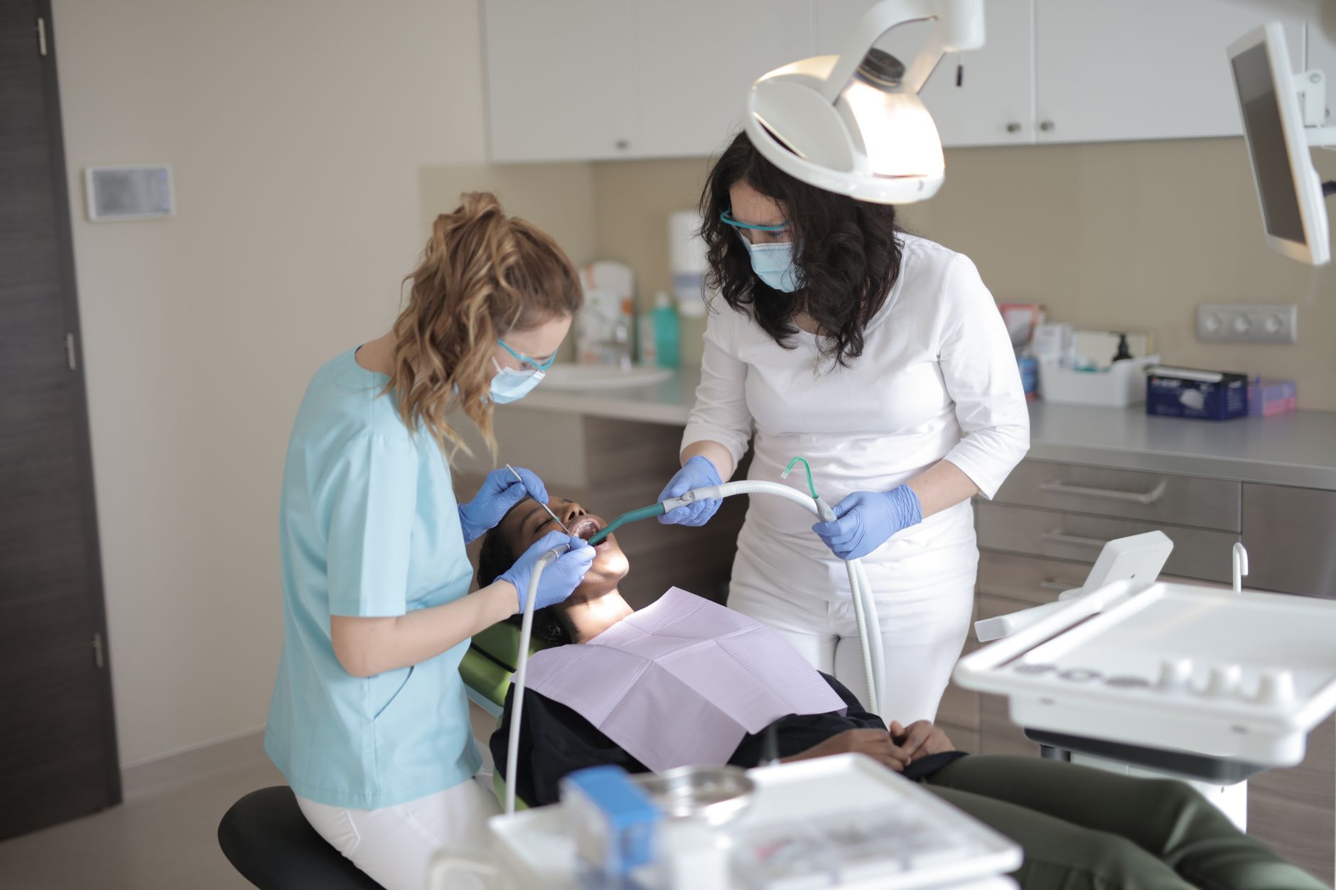 Dentist performing an examination on a patient in a clinical setting