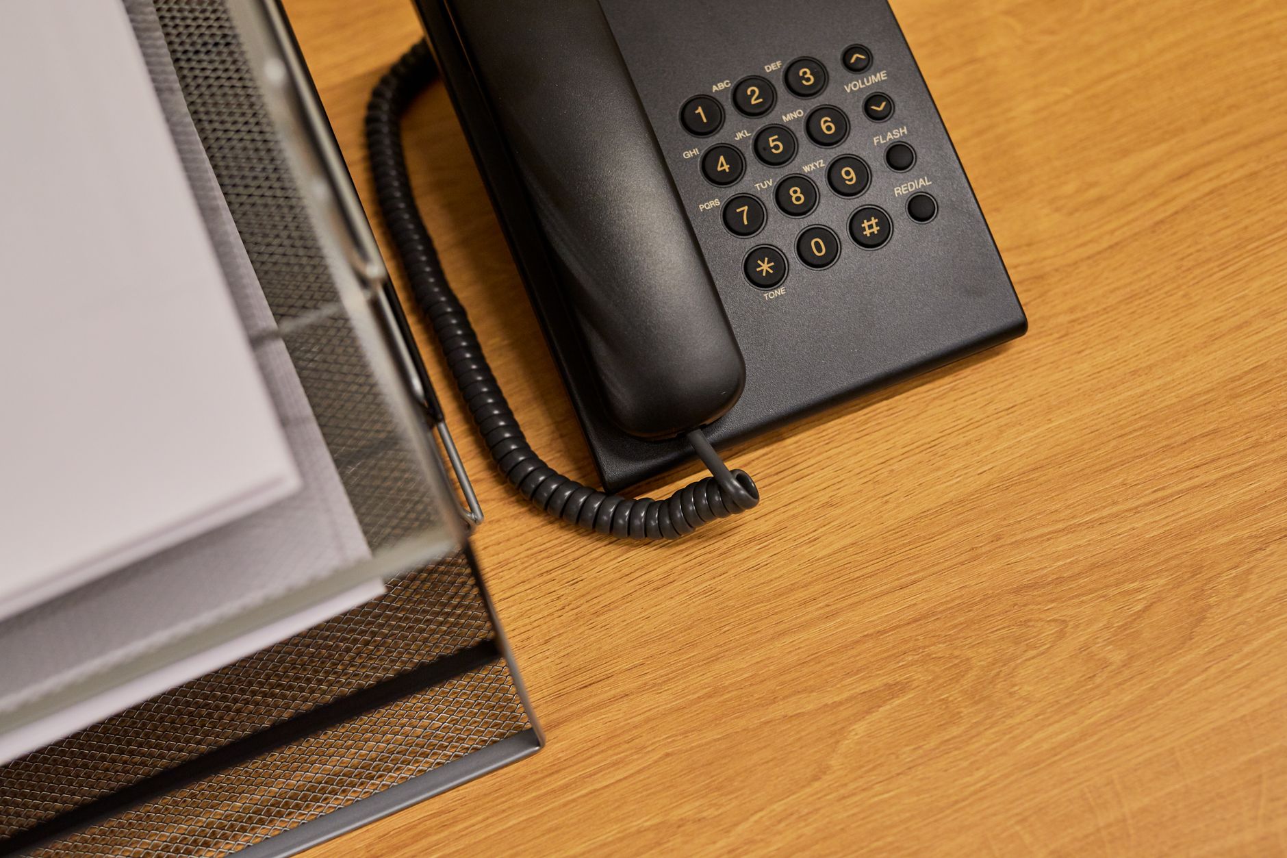 Business paperwork and files spread across an office desk