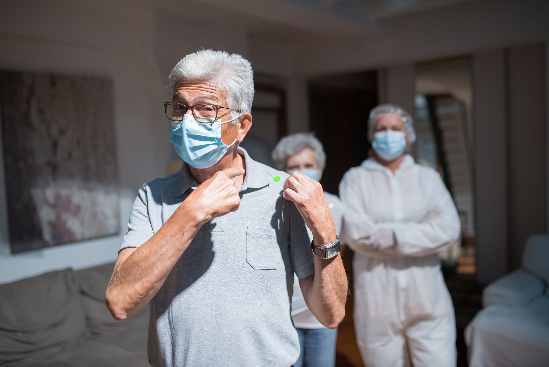 An elderly person receiving in-home health assistance from a caregiver