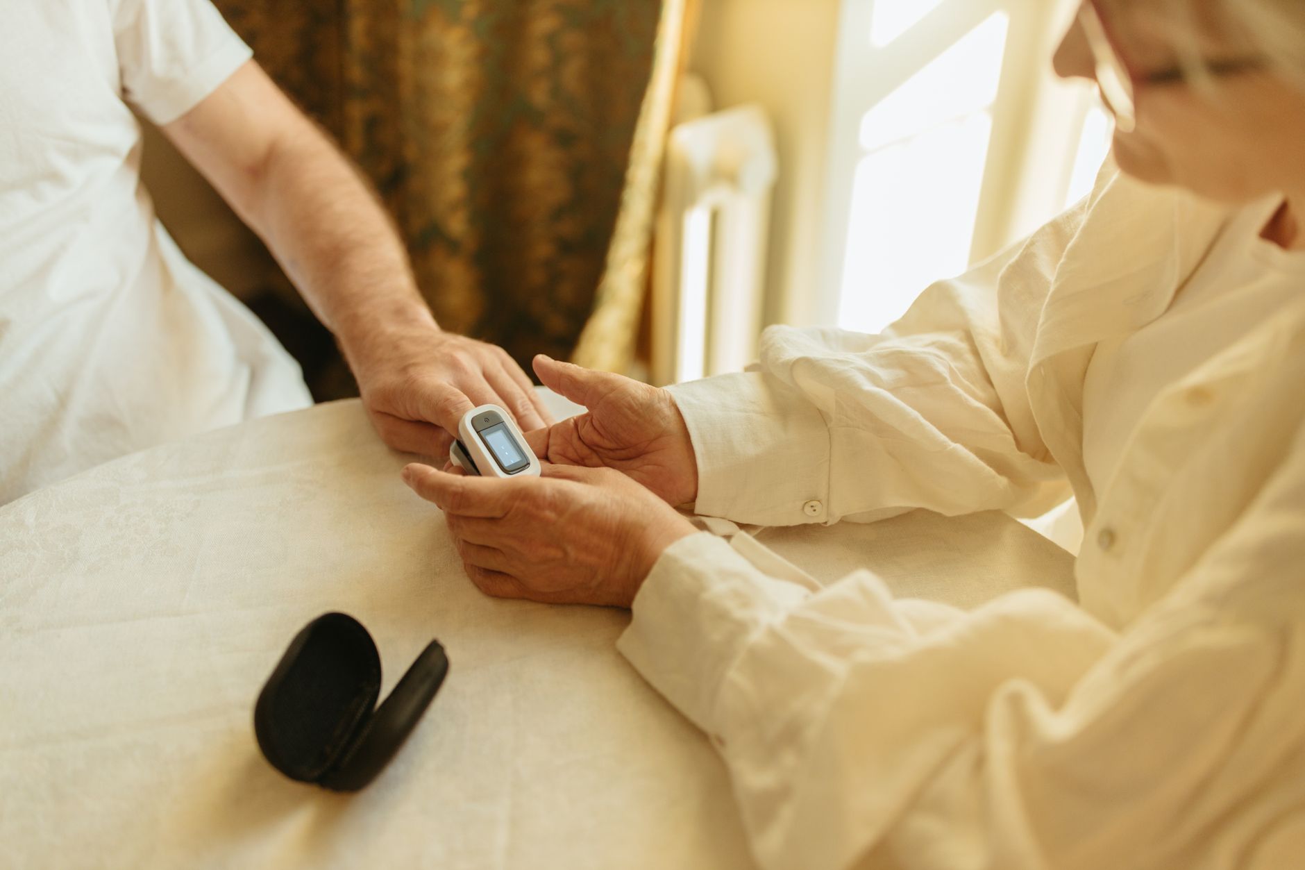 Nurse assisting an elderly patient in a clinical care setting