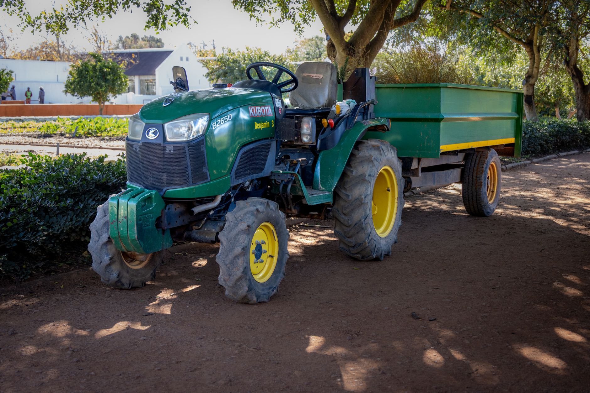 Farm tractor working in an open field during growing season