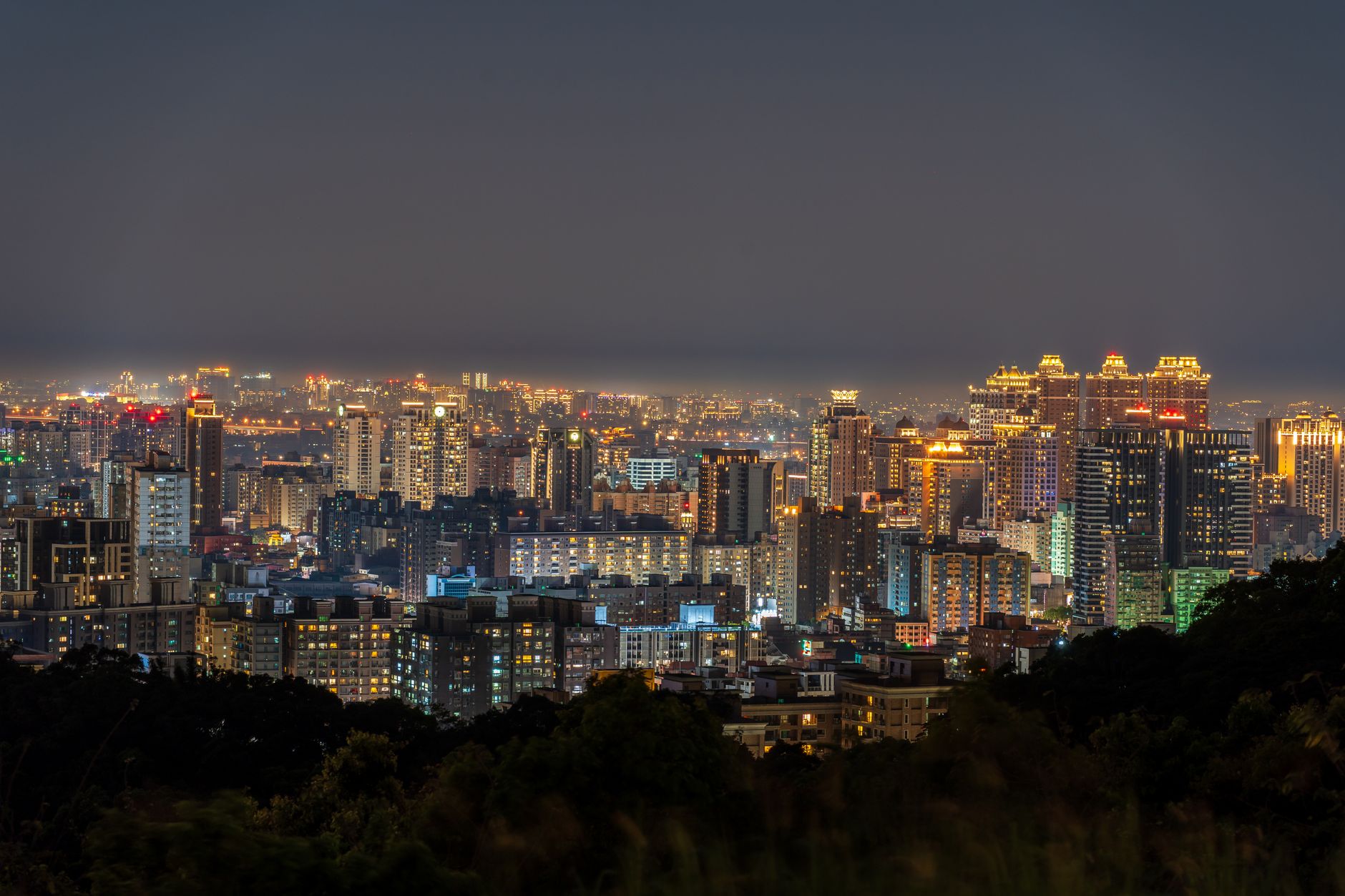 City skyline at night with commercial high-rise buildings lit against a dark sky