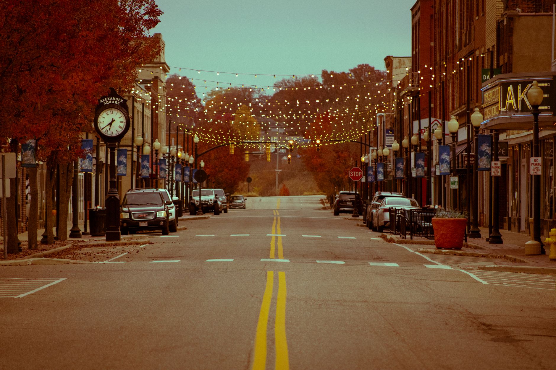 Main street of a small American town showing local storefronts and a financial services building