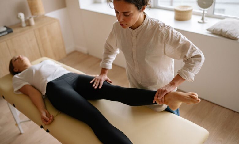 A physical therapist working with a patient in a clinical rehabilitation setting