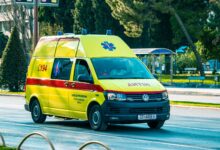 An ambulance parked outside a medical facility representing ground transport services
