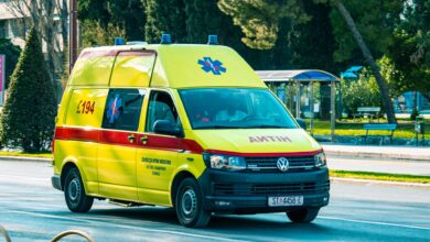 An ambulance parked outside a medical facility representing ground transport services