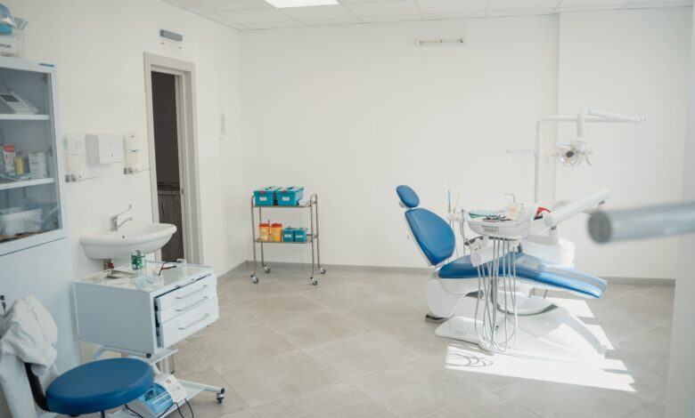Empty dental clinic waiting room with chairs and reception desk