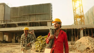 Construction workers on an active job site wearing safety helmets and vests