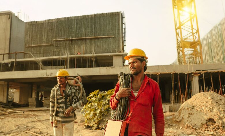 Construction workers on an active job site wearing safety helmets and vests
