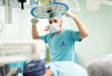 Orthopedic surgeon reviewing patient X-ray in a clinical setting