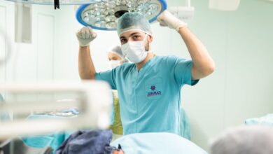 Orthopedic surgeon reviewing patient X-ray in a clinical setting