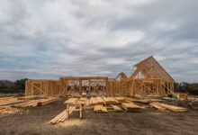 Aerial view of a residential construction site with framed homes and cleared land
