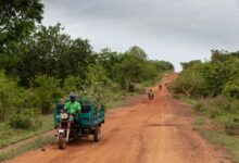 A delivery van on a remote rural road representing medical supply logistics in remote areas