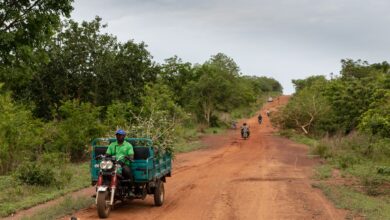 A delivery van on a remote rural road representing medical supply logistics in remote areas