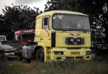 A large fleet of commercial trucks parked in a logistics yard