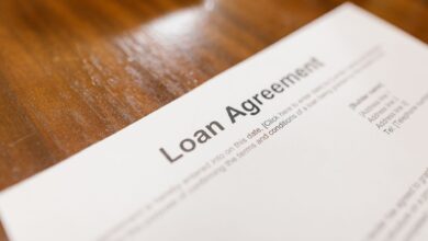 Stack of mortgage loan documents on a desk representing FHA servicing portfolios