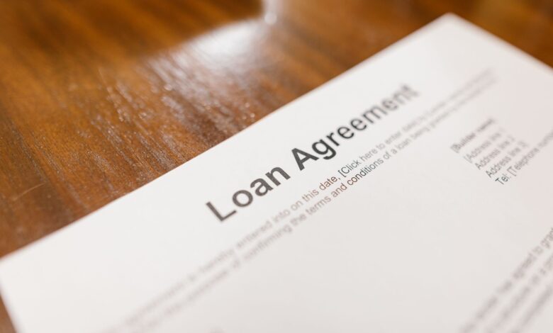 Stack of mortgage loan documents on a desk representing FHA servicing portfolios