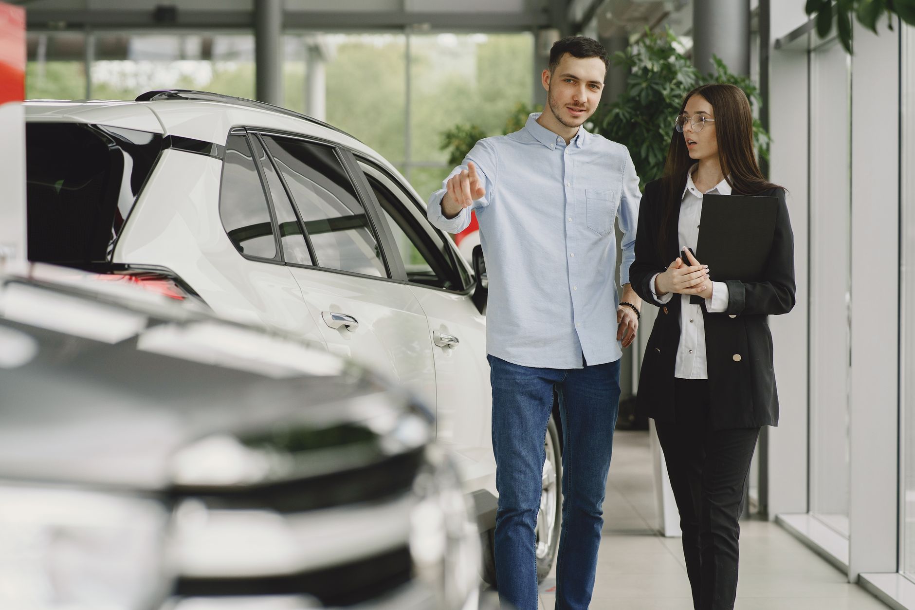 Inside view of a regional auto dealership showroom with vehicles on display