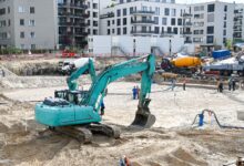 Civil engineers reviewing blueprints at an active construction site